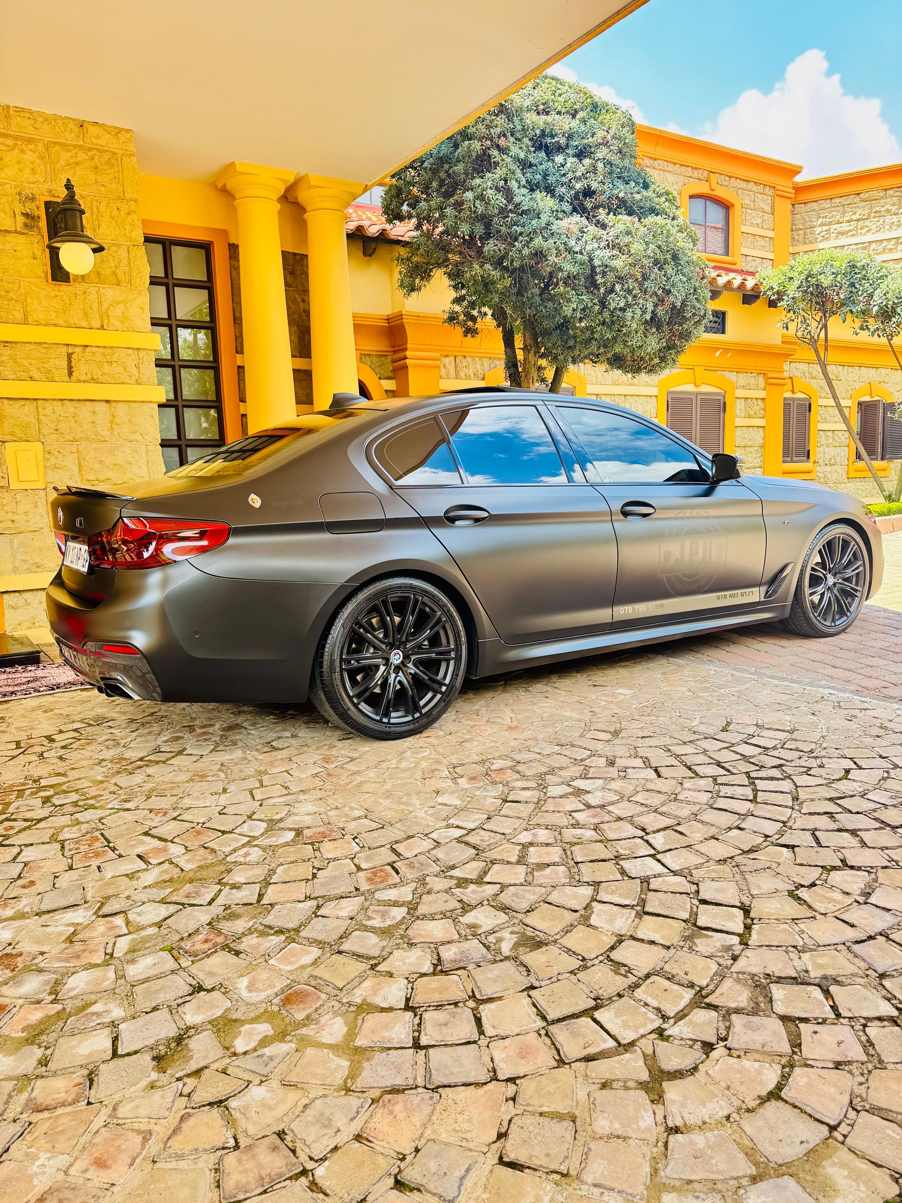 JPU executive protection BMW sedan with company branding